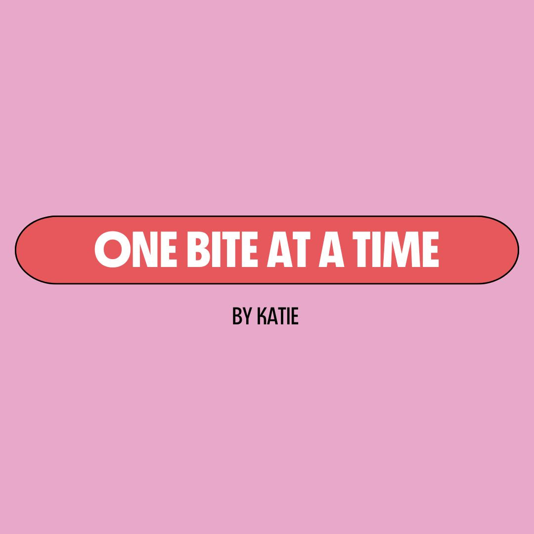 Pink background with a red text box containing white writing that reads: "one bite at a time." Underneath is black writing that reads: "by Katie."